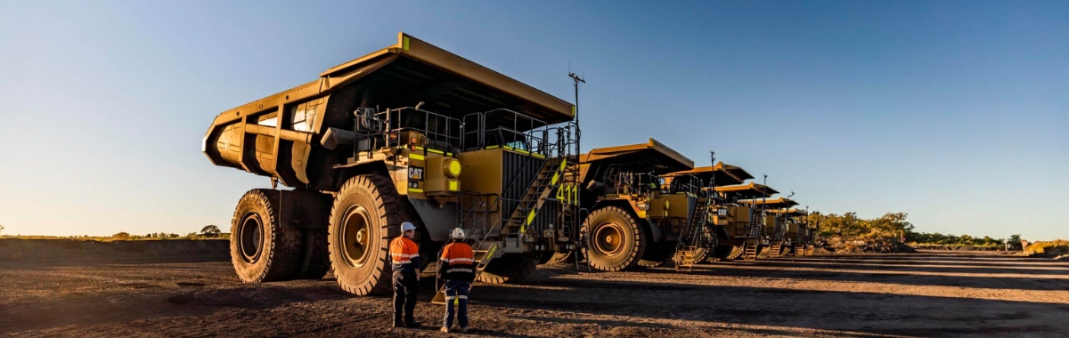 Fleet of Caterpillar dump trucks with sound attenuation kits installed